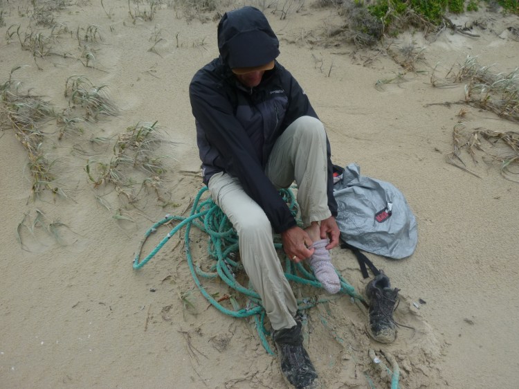 Larry wringing out his his waterloged socks